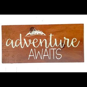 Hand-cut, hand painted, hand distressed “Adventure Awaits” Sign.